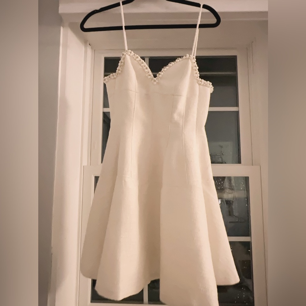 White mini dress with pearl on the chest